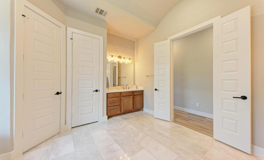 Bathroom is equipped with marble flooring, private water closet and separate linen closet. 