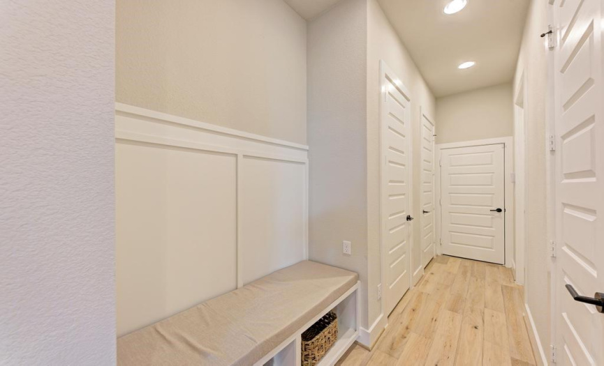 Kitchen hallway features a large pantry, two storage closets, laundry closet, and garage access. 