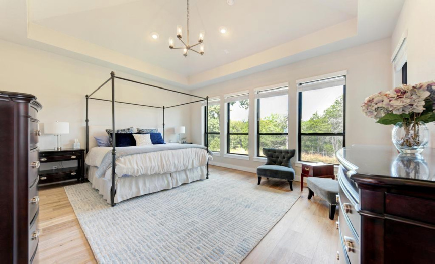 Large primary bedroom with cathedral ceilings.  