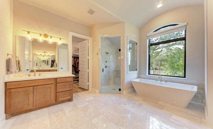 Fully marbled shower with marble throughout the entire bathroom. Two vanities sit back to back with double storage. 